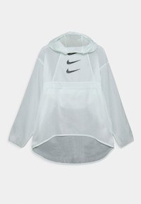Rompevientos verde claro con capucha, con logotipos negros de Nike en el pecho, mangas largas, dobladillo asimétrico y una textura de tela translúcida.