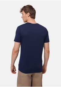 Marineblaues T-Shirt mit kurzen Ärmeln und Rundhalsausschnitt, aus weichem Stoff gefertigt. Verfügt über ein kleines Logo am unteren Saum, glatte Textur.