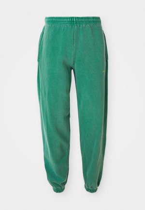 Green sweatpants with a relaxed fit, elastic waistband, and cuffs. Features side pockets and a small logo accent in yellow. Soft texture.