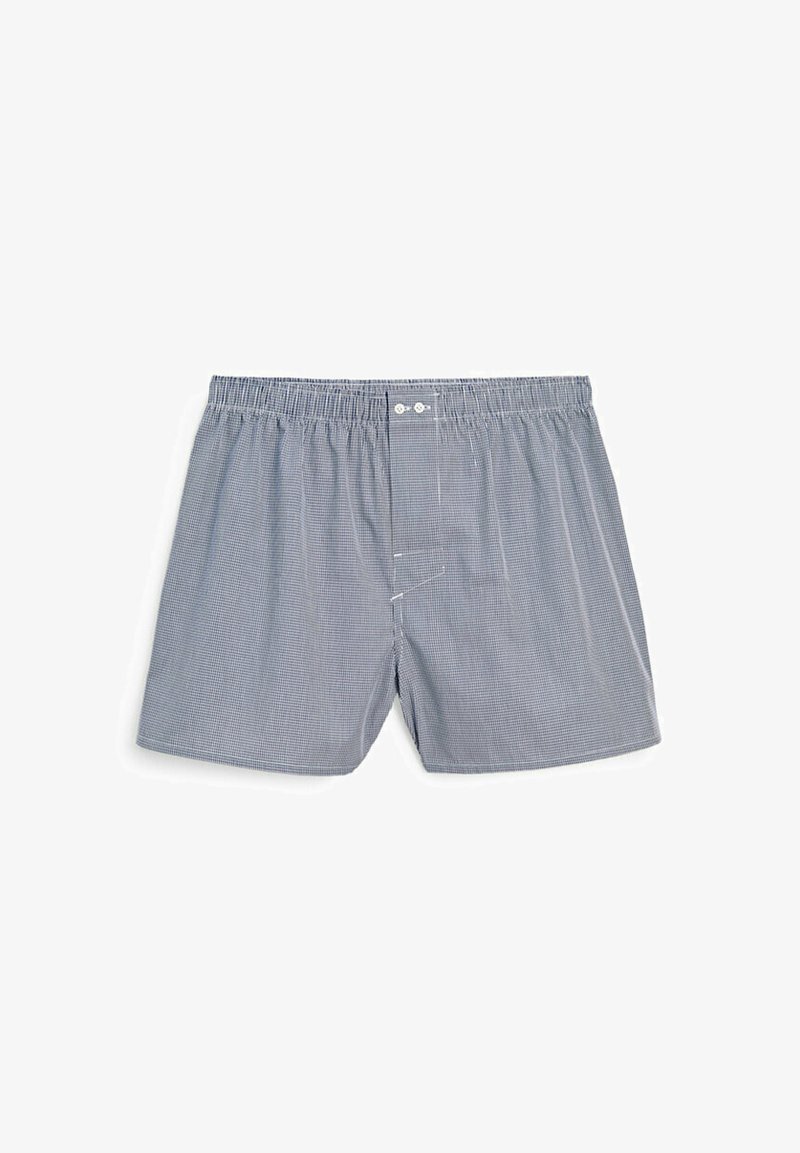 Boxer blu e bianchi a quadri realizzati in cotone morbido. Presentano un cinturino elastico e due bottoni frontali. Vestibilità ampia con aperture laterali.