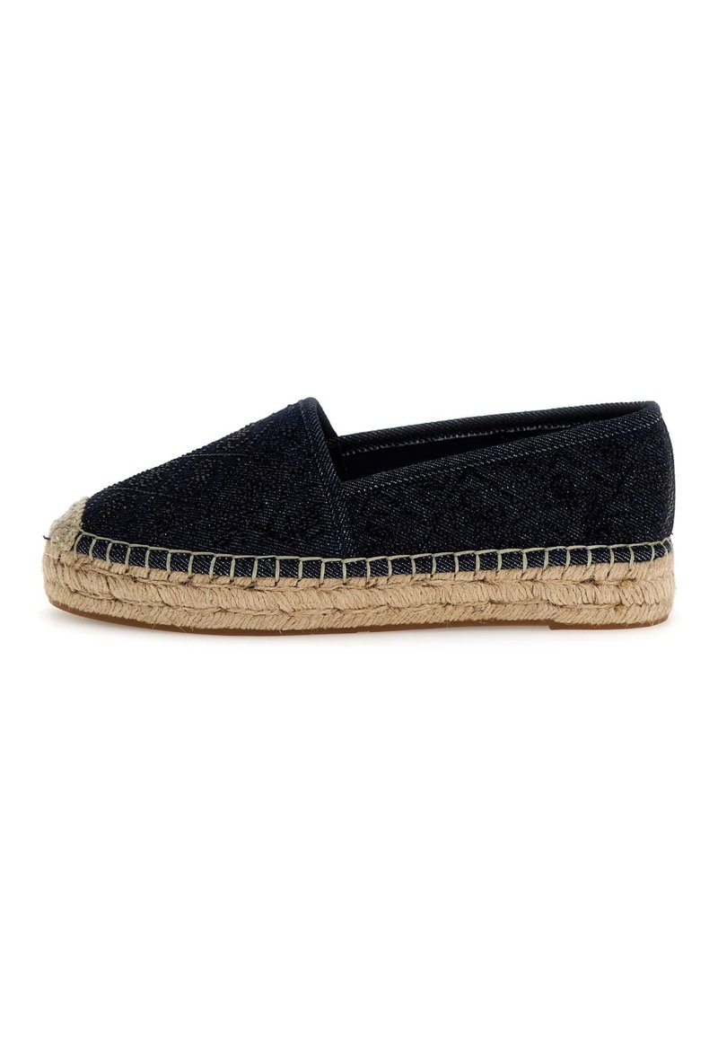 Navy textile espadrille with woven jute sole, closed toe, and unique patterned texture. Features a flat profile and soft fabric upper.