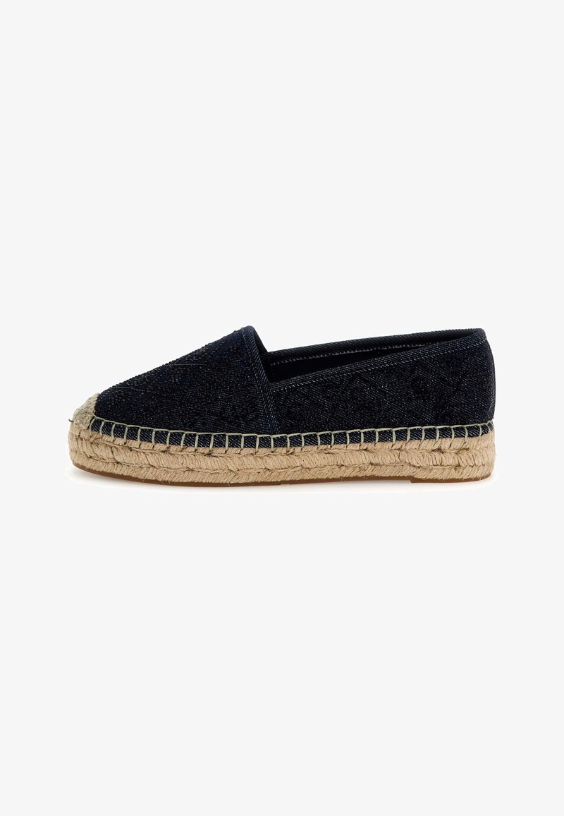 Espadrille en textile navy avec semelle en jute tressé, bout fermé et texture à motif unique. Présente un profil plat et une tige en tissu doux.