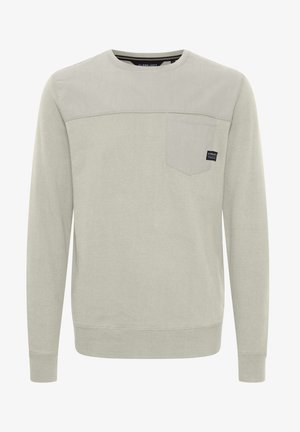 Lichtgrijze sweatshirt met een ronde hals, lange mouwen en een borstzak. Heeft een twee-kleurig ontwerp met een soepele textuur.