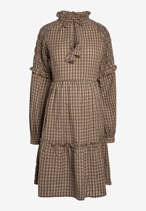 Vestido a cuadros en marrón y beige con mangas largas, acentos con volantes, un escote alto y una falda de capas. Incluye un detalle de lazo en el cuello.