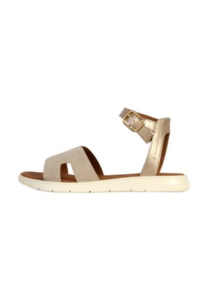 Beige suede sandal with an ankle strap, adjustable buckle, and a lightweight white sole. Features open toe and two wide straps across the instep.