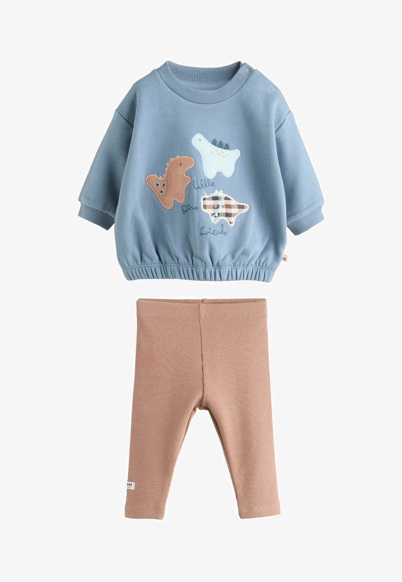 Sweat-shirt bleu avec des appliqués de dinosaures, taille élastique et poignets côtelés, associé à des leggings beiges côtelés. Tissu en mélange de coton doux.