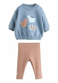 Niebieska bluza z aplikacjami dinozaurów, elastycznym pasem i ściągaczami, zestawiona z beżowymi, prążkowanymi legginsami. Miękka tkanina bawełniana.