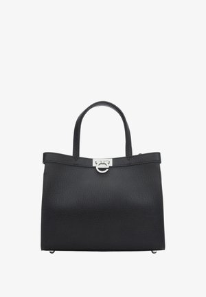 Sac à main en cuir noir texturé avec doubles poignées, fermoir en cercle et rectangle argenté, et base rectangulaire plate avec pieds en métal.