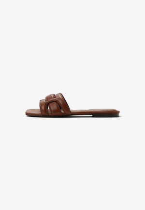 Brown leather flat sandals with two intertwined straps, flat sole, and minimalistic design. Smooth texture and flexible fit.