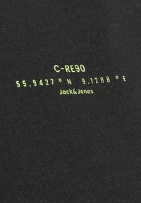 Black cotton t-shirt with bright green text displaying "C-RE90" and coordinates "55.9427° N 9.1288° E", by Jack & Jones.