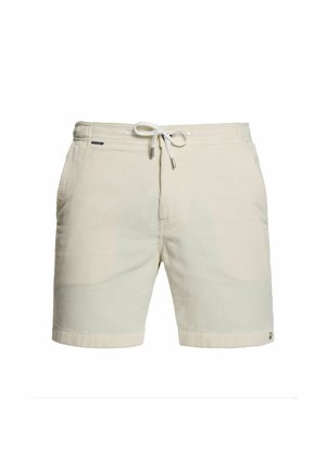 Cream corduroy drawstring shorts with side pockets and a small black brand label on the waistband.