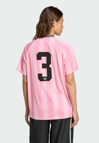Pink striped jersey featuring a large black "3" on the back. Made of smooth fabric with a crew neck and short sleeves.
