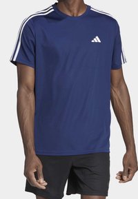 Navy blue athletic t-shirt with white stripes on shoulders, round neck, made of breathable fabric, featuring a small white logo on the chest.