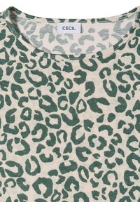 Tissu beige avec un motif léopard abstrait vert foncé et un col rond, comportant une étiquette de marque "CECIL" au dos du col.