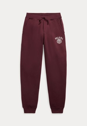 Pantalon de survêtement marron avec taille élastique et cordon de serrage, poches avant, chevilles élastiquées et logo blanc "POLORI" sur la cuisse gauche.