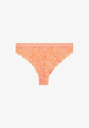 Peach lace thong with floral detailing. Features a logoed elastic waistband and scalloped edges. Delicate and semi-transparent texture.