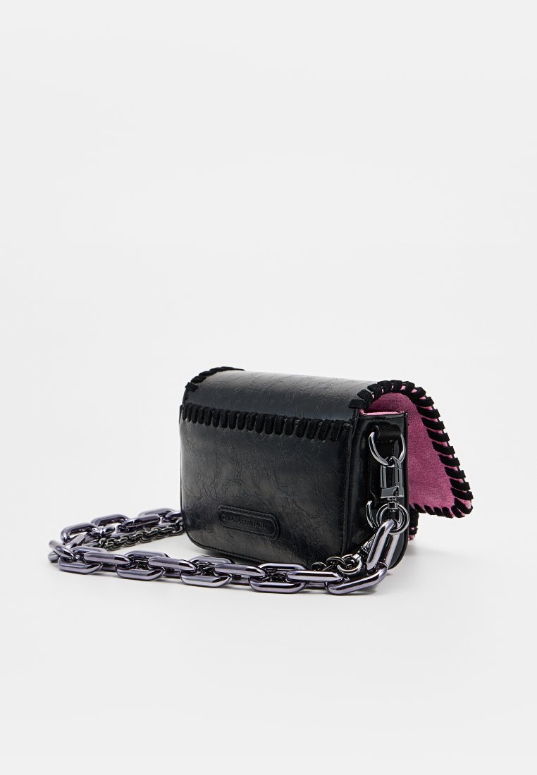 Sac à main en cuir noir avec un intérieur en daim rose, présentant des coutures décoratives et une bandoulière en chaîne argentée. Forme rectangulaire compacte.