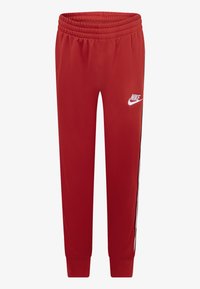 Pantaloni tuta rossi in poliestere con vita elastica, vestibilità slim e logo Nike bianco sulla coscia sinistra; presenta righe nere sui lati.