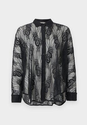 Blouse noire à manches longues avec boutons, motif en dentelle florale, col et poignets unis, tissu semi-transparent, présentée sur fond uni.