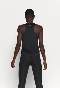 Camiseta deportiva negra sin mangas con escote redondeado y diseño de espalda nadadora, hecha de tela ligera, que presenta un pequeño logo blanco en la parte posterior.