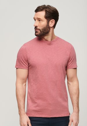 T-shirt à manches courtes col rond en rose chiné avec une coupe décontractée. Tissu doux, texture subtile et design d'ourlet épuré.