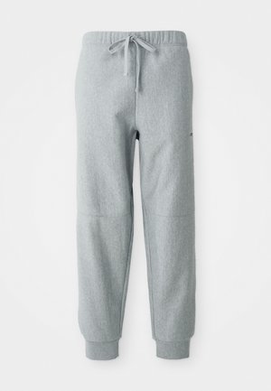 Grau Fleece-Jogginghose mit elastischem Bund, Kordelzug und Bündchen an den Knöcheln. Verfügt über strukturierten Stoff und subtile Nahtdetails.