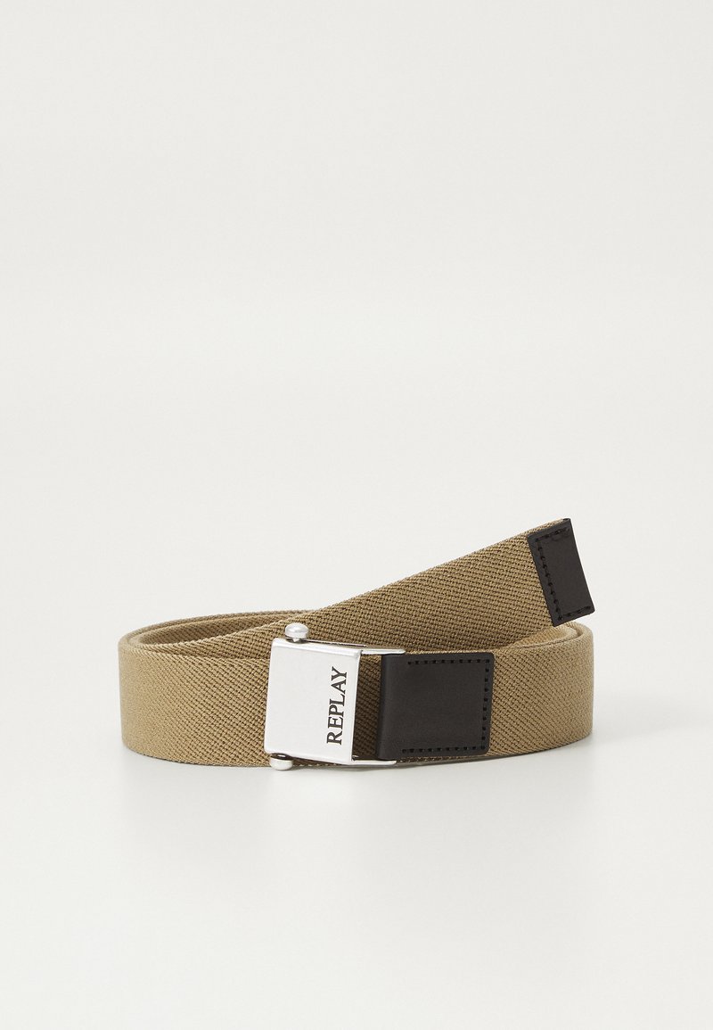 Tan fabric belt with a smooth texture and metal buckle. The buckle features a silver finish with 'REPLAY' engraved; ends have dark leather accents.