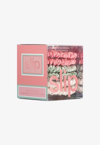 Set of six skinny silk scrunchies in pink, green, and cream, displayed in a clear box with a pink and teal label featuring the brand name.