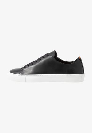 Black leather sneaker with a smooth finish, white rubber sole, and black laces. Features a subtle logo on the side and a contrasting heel tab.