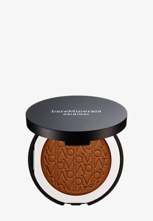Bronzer compact avec un couvercle noir et une base blanche. À l'intérieur, une poudre bronzante lisse et en relief de couleur bronze avec le lettrage de la marque. Forme circulaire, texture matte.