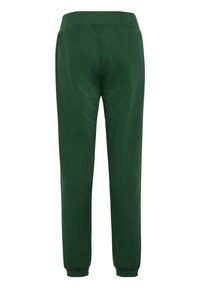 Grüne Jogginghose mit geradem Schnitt, aus weichem Stoff. Verfügt über einen dehnbaren Bund und bündchenförmige Beine. Keine sichtbaren Taschen.