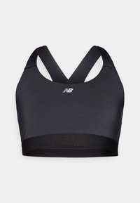 Brassière de sport noire avec des bretelles croisées dans le dos, fabriquée à partir d'un matériau lisse et extensible. Présente un logo à l'avant et une large bande élastique en bas.