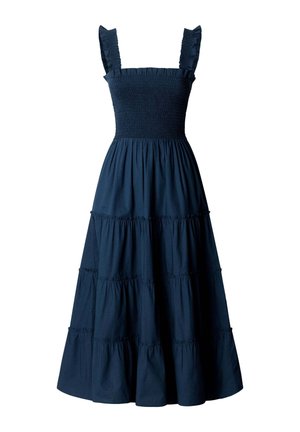 Robe maxi bleu marine sans manches avec corsage smocké, bretelles à volants et jupe à volants froncés en plusieurs rangs.