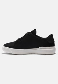 Black athletic shoes with a smooth upper material, rounded toe, white rubber sole, and subtle stitching accents. Minimalist design.