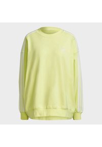 Svetle zelená mikina s volným střihem, kulatým výstřihem, bílým logem Adidas a bílými pruhy na rukávech. Měkká textilie.