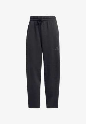 Pantalons de survêtement noirs en tissu doux, dotés d'une taille élastique avec cordon de serrage, de jambes droites et d'un logo discret sur la cuisse.