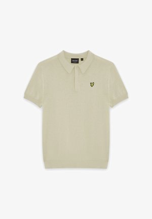 Beige kortærmet polo med krave, knaplukning, ribstrikkede manchetter og lille gul og sort fuglelogo på brystet.