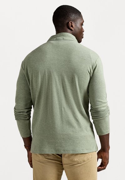 Long-sleeve polo shirt in muted green, made from soft material. Features a collar, fitted sleeves, and a straight hem. Minimalist design.