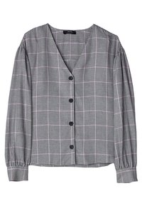 Blusa a scacchi bianca e nera con scollatura a V, maniche lunghe a sbuffo e sei bottoni neri sul davanti. Tessuto morbido con polsini arricciati.