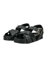 Schwarze Sandalen mit offenen Zehen, Kreuzriemen und einem Schnallenverschluss, ausgestattet mit einem strukturierten Lederoberteil und einer stabilen Plattformsohle für Unterstützung.
