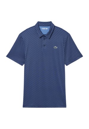 Polo de hombre Lacoste Sport azul marino con patrón texturizado completo y el icónico logo de cocodrilo en el pecho.