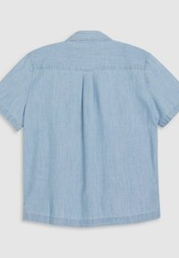 Chemise bleu clair à manches courtes avec un empiècement droit au dos et un pli en boîte central, présentée à plat sur un fond blanc.