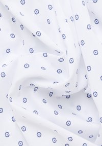 Lightweight white fabric featuring a repeated blue floral pattern, with hexagonal shapes and a smooth texture.