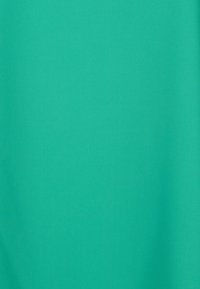 Turquoise fabric with a smooth texture. It exhibits a solid color without patterns, showcasing even, consistent shading.
