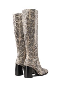 Stivali alti fino al ginocchio con motivo in pelle di serpente, caratterizzati da una superficie liscia, tonalità neutre beige e nere, con tacchi neri spessi.