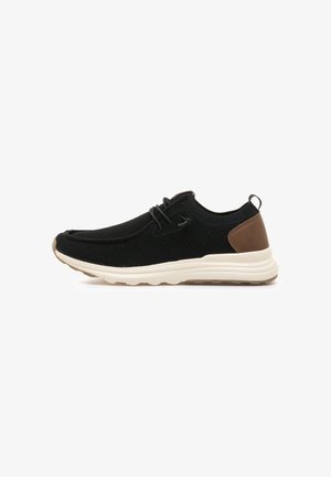 Zapatillas de malla negras con puntera redondeada, media suela de crema y acento de cuero marrón en el talón. Presenta cordones y una lengüeta.