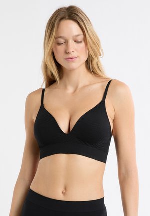 Zwarte bralette met een diep uitgesneden halslijn, verstelbare bandjes en een geribbelde textuur. Voorzien van een brede band voor ondersteuning en een naadloos ontwerp.
