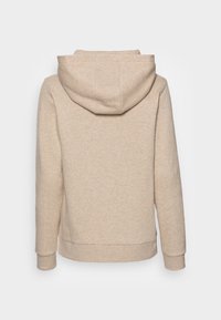 Beige huvtröja med mjuk yta, med långa ärmar, en framfickor i känguru-stil samt ribbad mudd och nederkant.