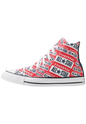 High-top Converse sneaker with red, white, and navy blue All Star and Converse logo pattern, white laces, and white rubber sole with black stripes.