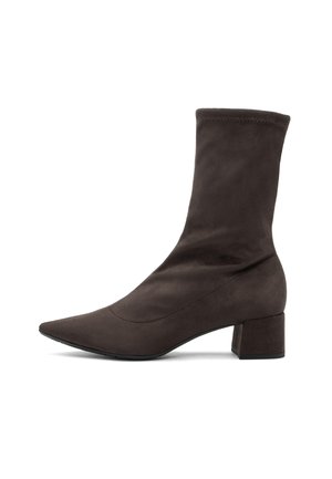 Brown suede ankle boot with a pointed toe and a block heel. The design features a fitted ankle shaft and minimal stitching for a sleek look.